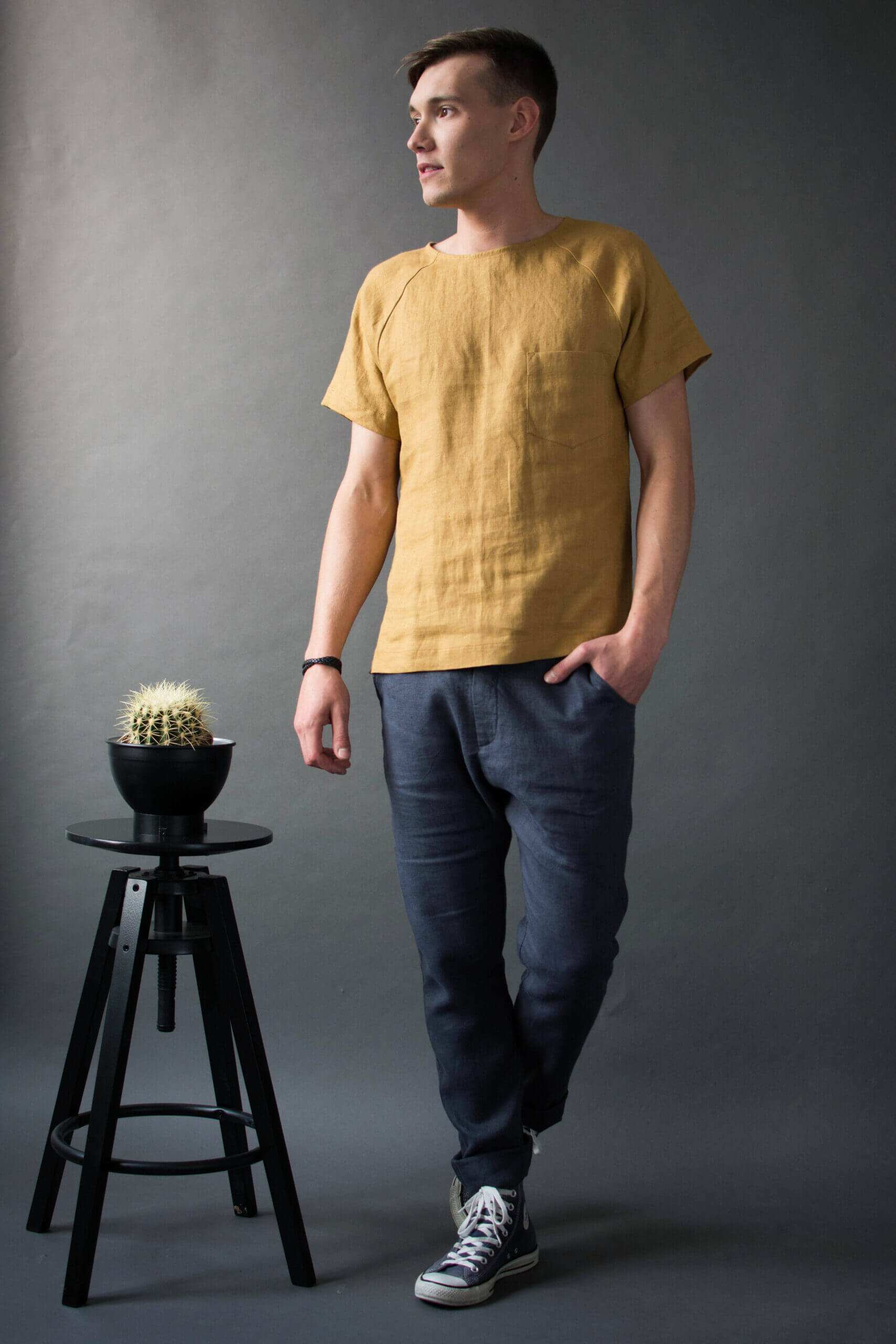 Mustard raglan t-shirt paired with graphite pants for a summer outfit