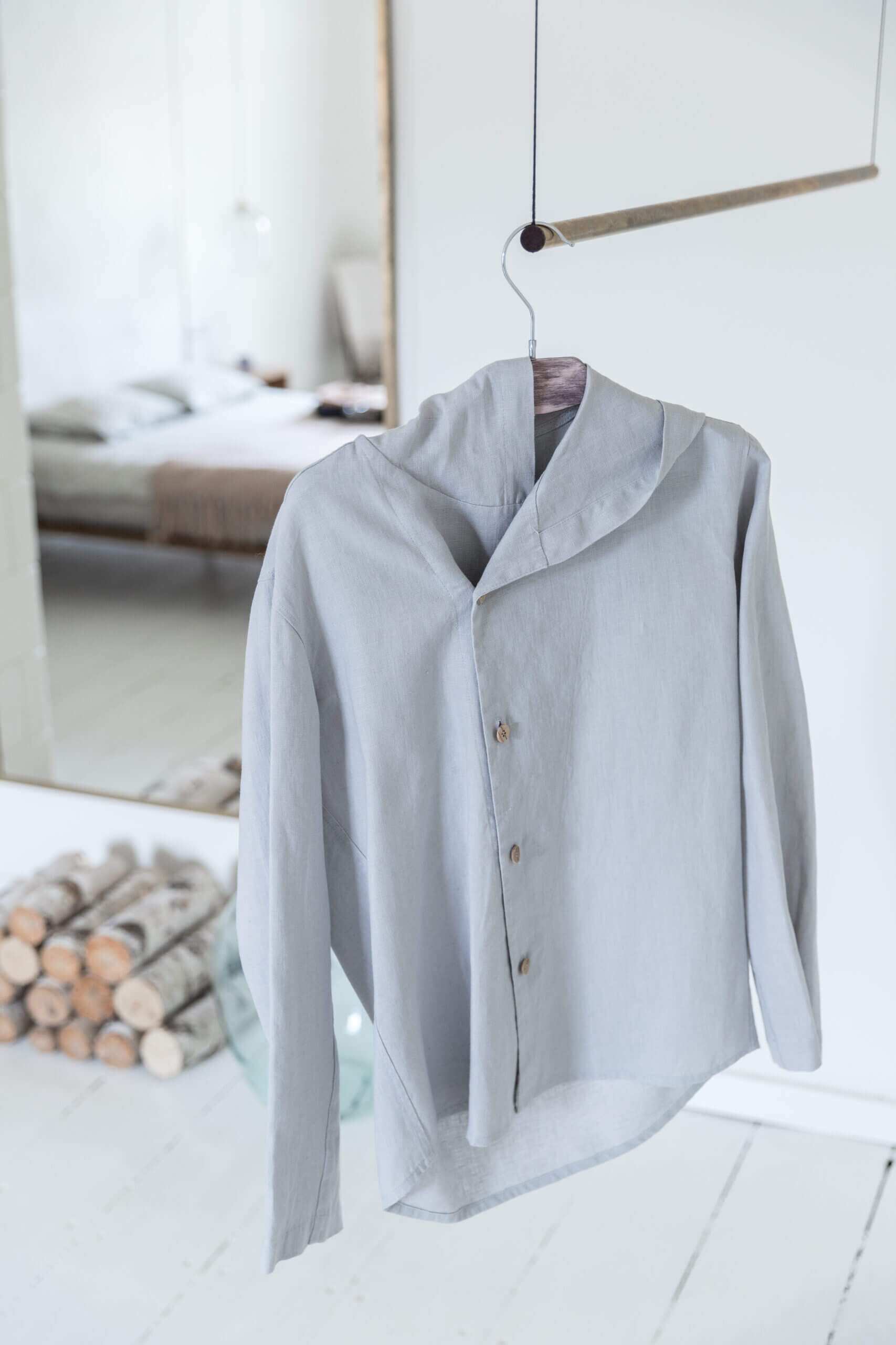 Light grey linen hoodie displayed gracefully on a hanger